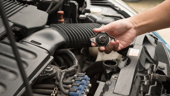 mechanic repairing car radiator