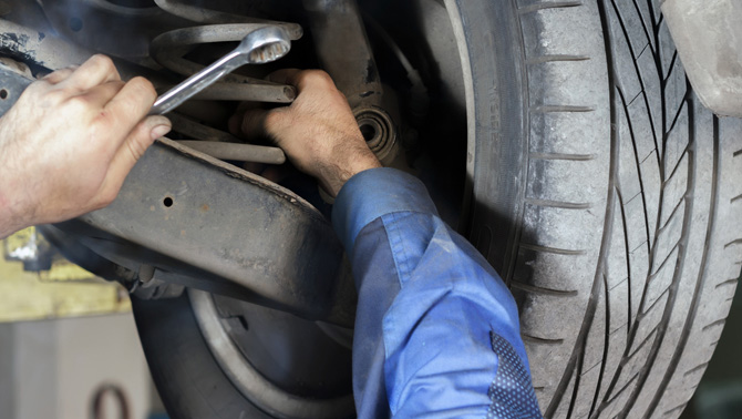 our mechanic fitting new shock absorbers